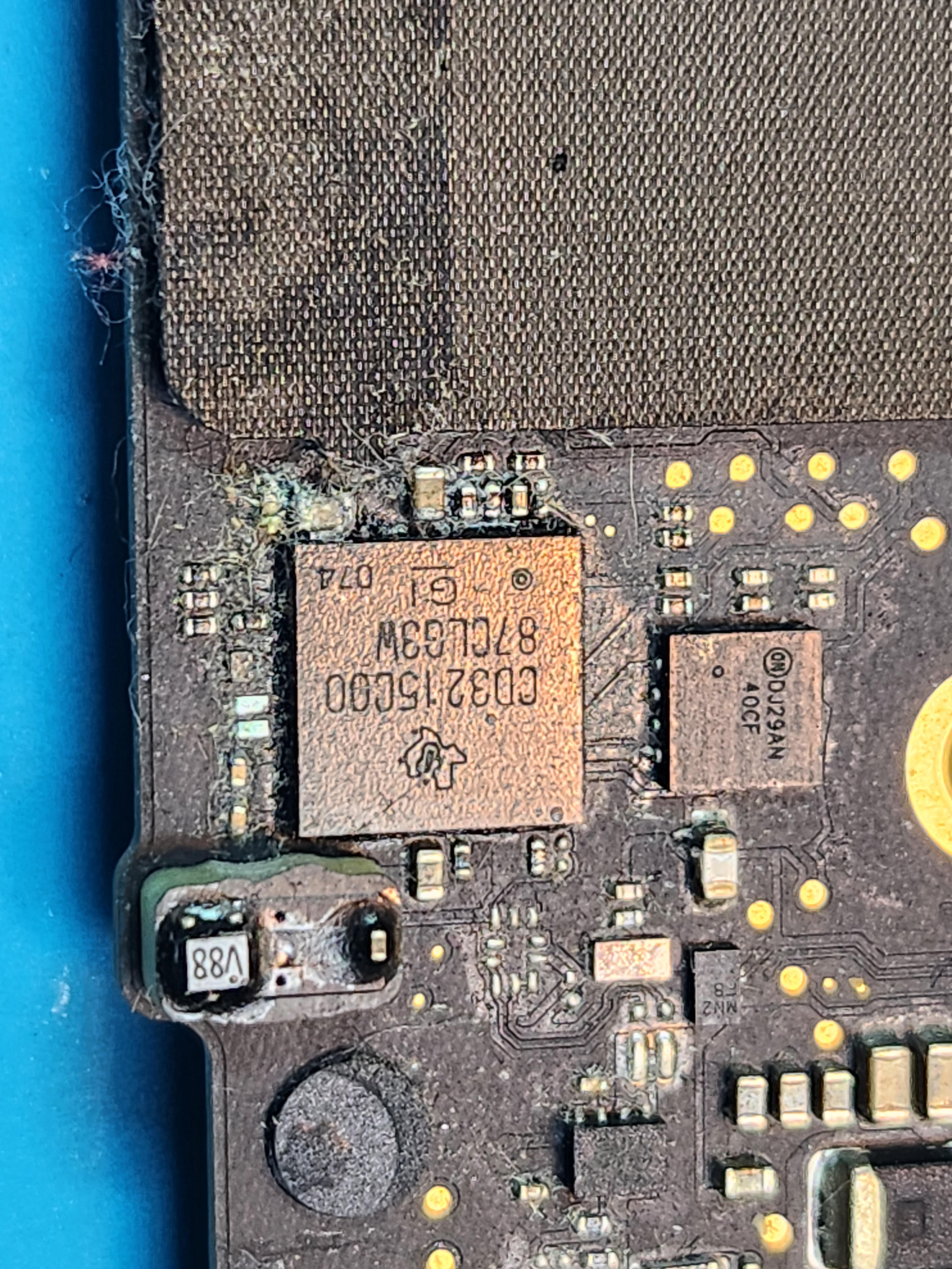 MacBook logic board with liquid damage corrosion before treatment